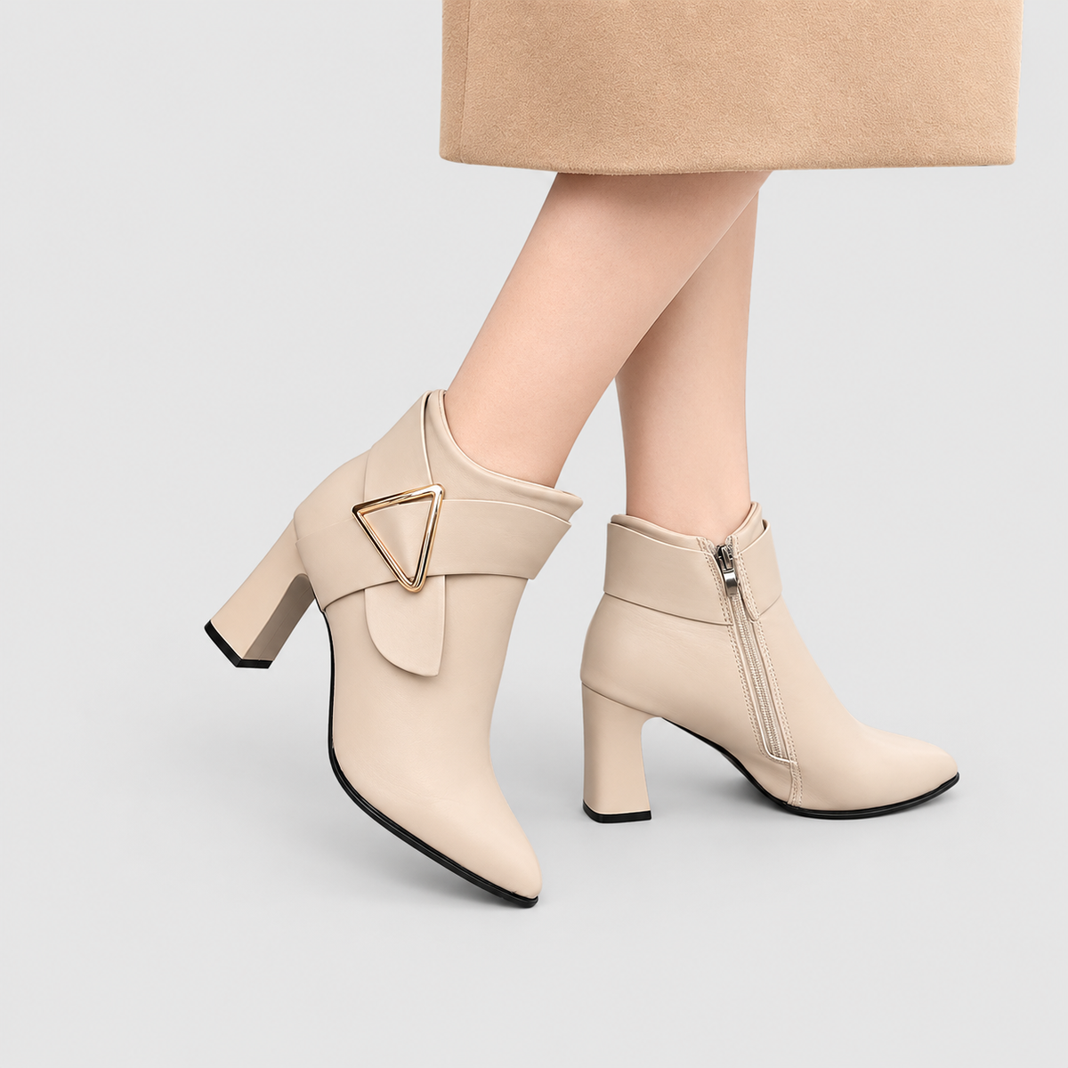 Women's Pointed-Toe Faux Leather Ankle Boots with Gold-Tone Triangle Buckle in Beige — view 1
